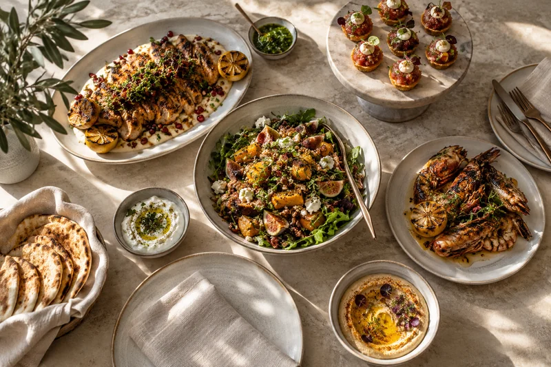 Sharing platters with roast chicken, colourful vegetables and small canapés