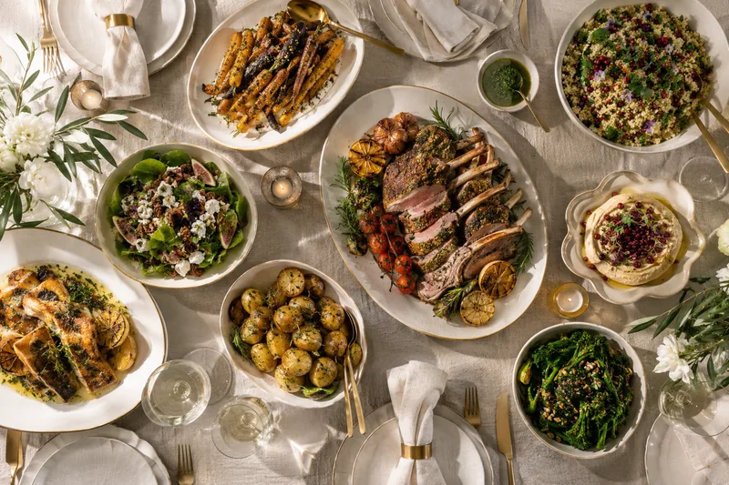 Formal dining dishes with a plated main and shared accompaniments