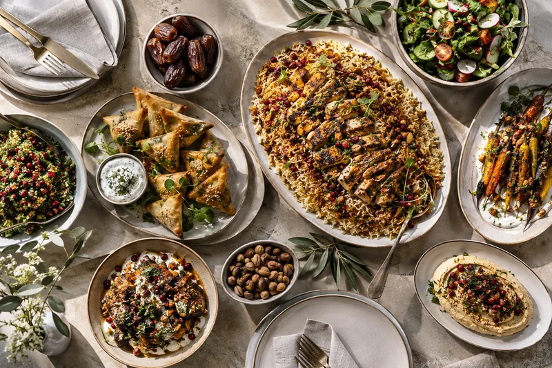 An overhead menu selection with spiced rice, savoury pastries and salads