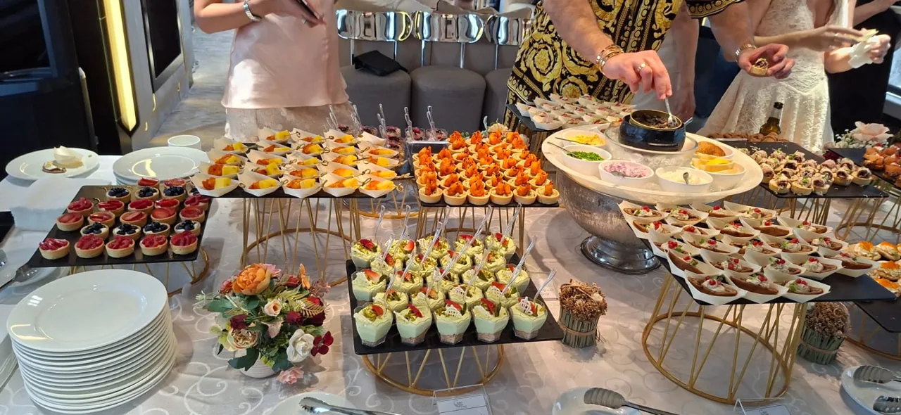 Assorted finger food and canapés arranged on tiered stands.