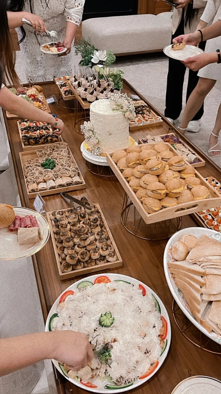 Canapé and finger-food spread being shared around a table.