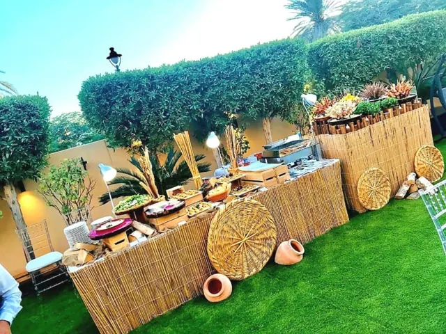 Garden catering display with woven panels and food stations.