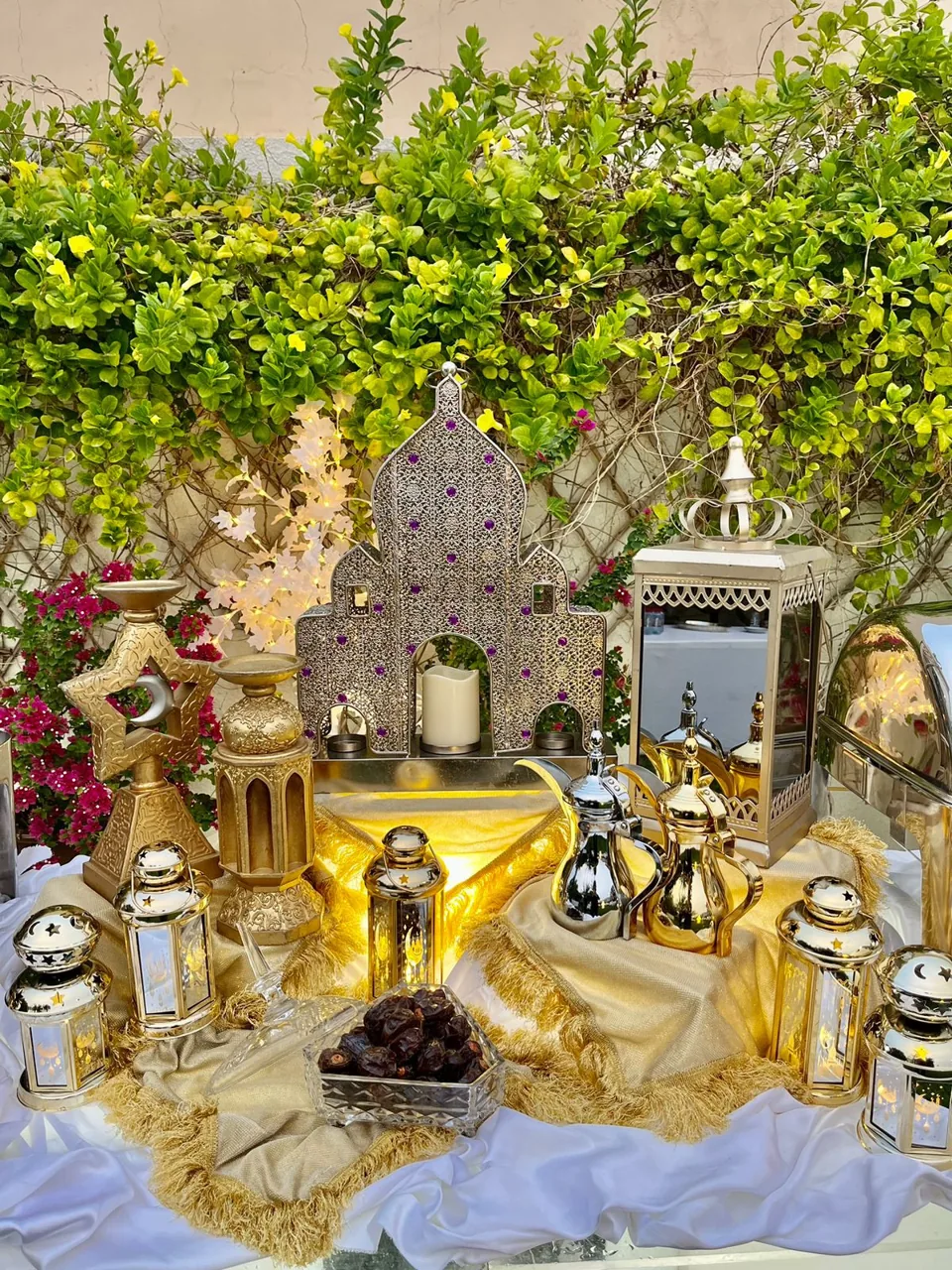 Garden Ramadan buffet with lanterns and ornate serving dishes.
