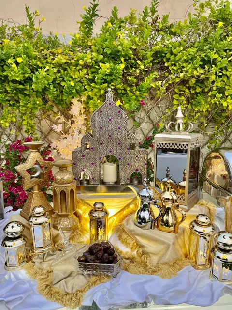 Garden Ramadan buffet with lanterns and ornate serving dishes.