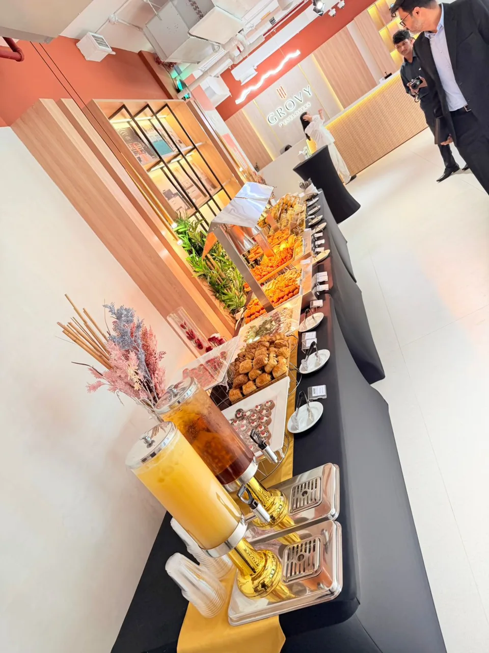 Long breakfast buffet with pastries, juices and warm dishes.