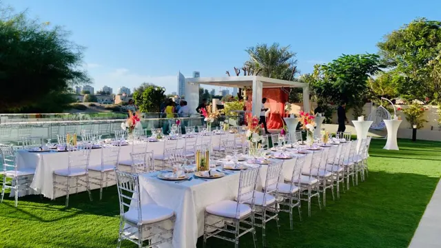 Long garden tables set for a daytime outdoor celebration.