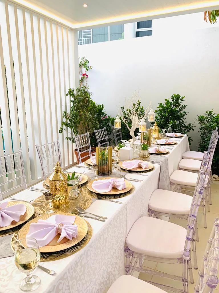 Private dining table with tall candles and delicate floral details.