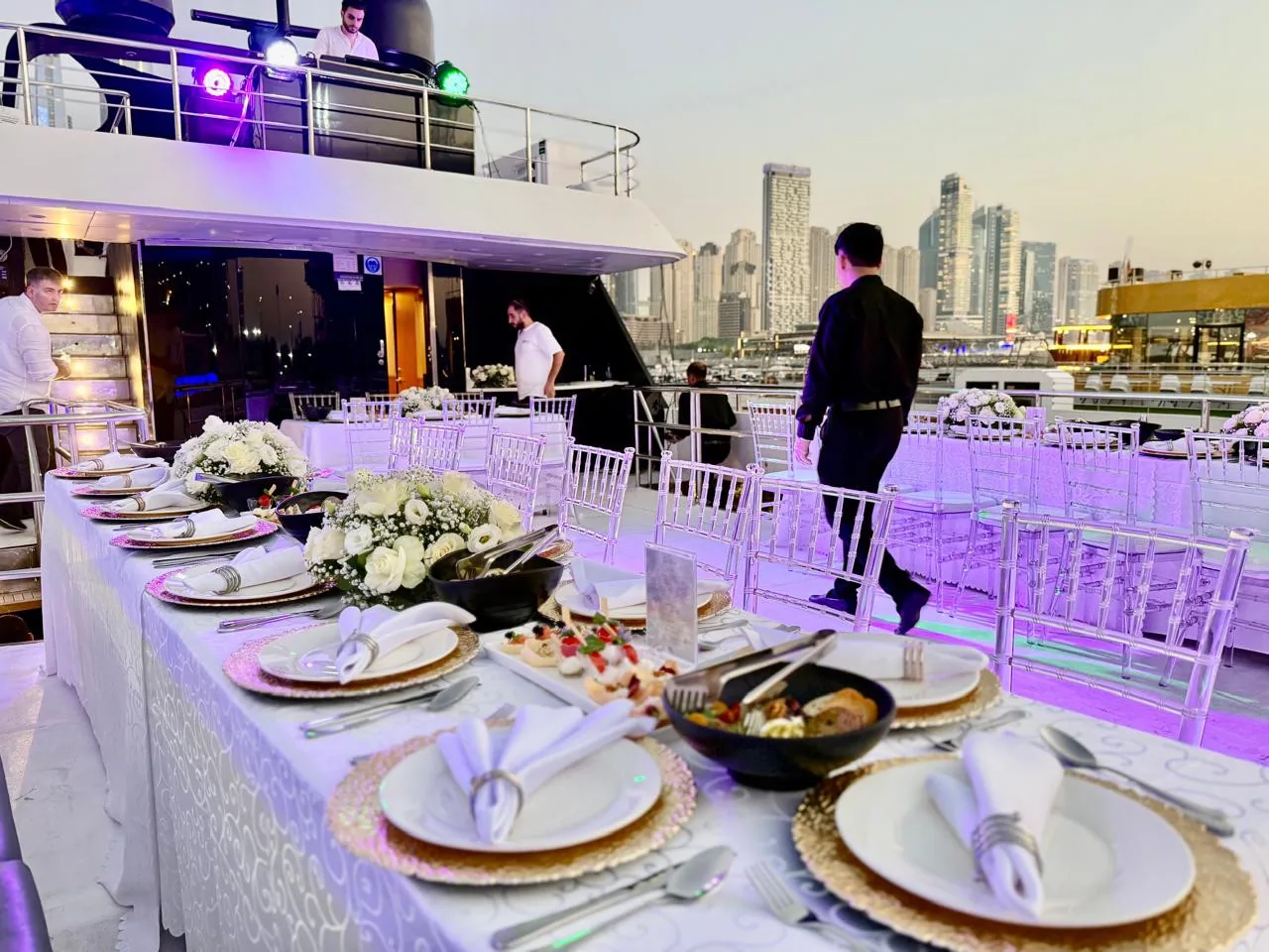 Yacht dining table with the marina visible beyond the deck.