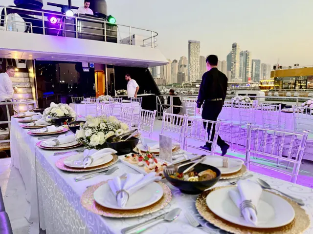 Yacht dining table with the marina visible beyond the deck.