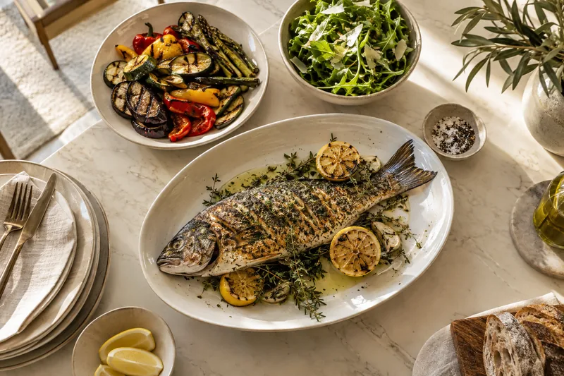 Roasted fish with herbs, grilled vegetables and a fresh green salad