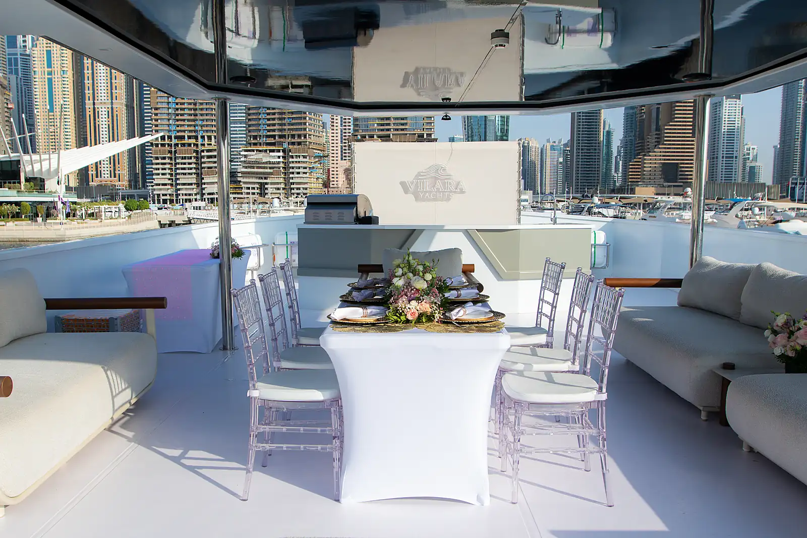 Seated table on a chartered Dubai yacht with the skyline behind it, from a previous myCHEF catering day.