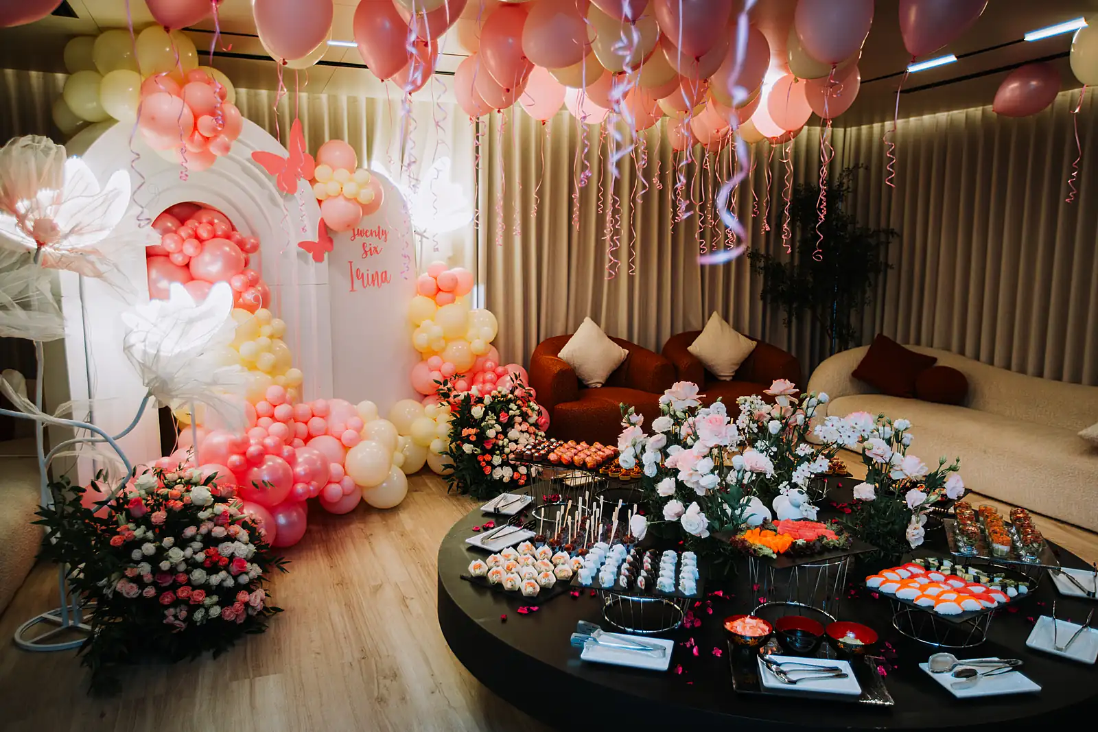 Round buffet table of sushi and canapés in a styled yacht salon, from a previous myCHEF catering day.