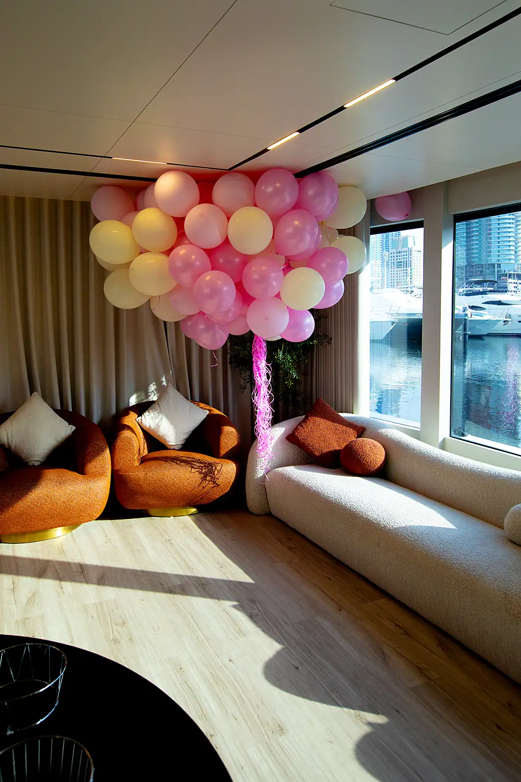 Yacht salon prepared for lounge dining with a marina view, from a previous myCHEF catering day.