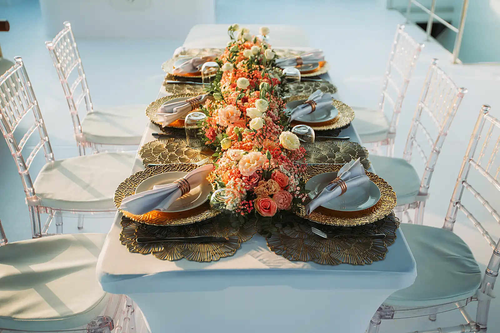Place settings and flowers on a seated yacht table, from a previous myCHEF catering day.